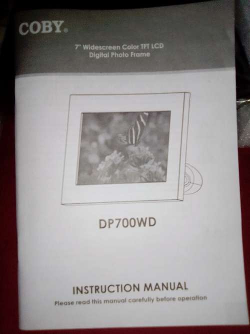A `Coby` 7 ` Digital photo frame plug in and play with Instructions and Charger in box.