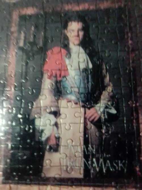 `The Man in the Iron Mask` staring Leonardo De Caprio Puzzel under glass in a solid wood frame.