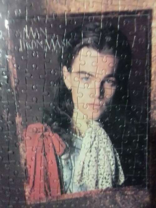 `The Man in the Iron Mask` staring Leonardo De Caprio Puzzel under glass in a solid wood frame.
