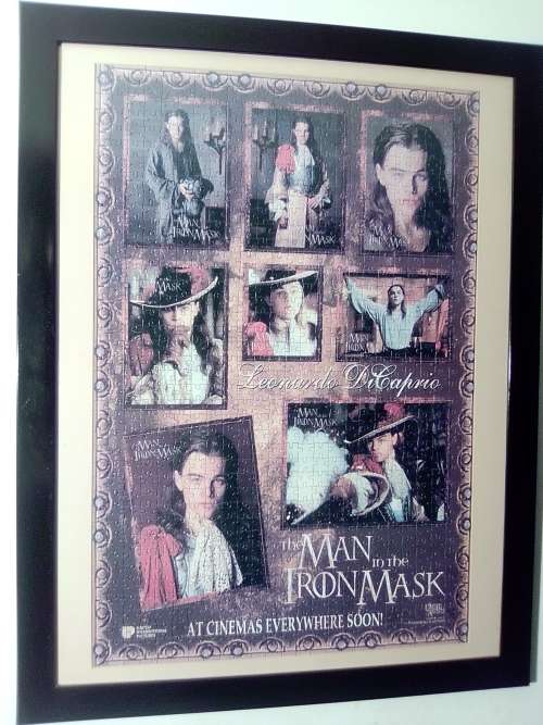 `The Man in the Iron Mask` staring Leonardo De Caprio Puzzel under glass in a solid wood frame.