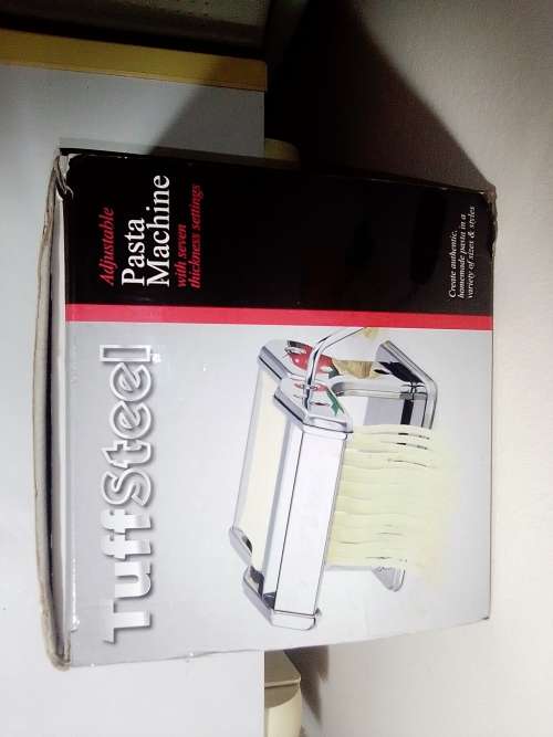 A boxed TUFFSTEEL Adjustable Pasta Machine complete with bracket and drive handle.