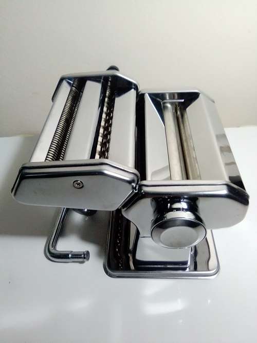 A boxed TUFFSTEEL Adjustable Pasta Machine complete with bracket and drive handle.