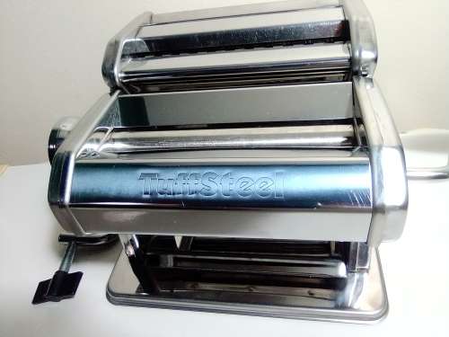 A boxed TUFFSTEEL Adjustable Pasta Machine complete with bracket and drive handle.