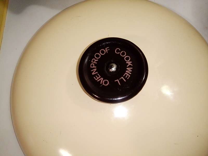 A very old vintage Cookwell blue/cream enamel lidded cooking pot + a cast iron milk boiler.