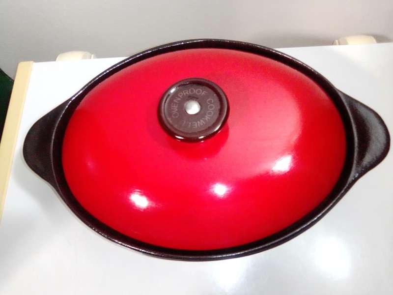 A vintage oval Cookwell Red lidded cast iron cooking pot in good condition.