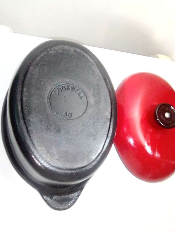 A vintage oval Cookwell Red lidded cast iron cooking pot in good condition.