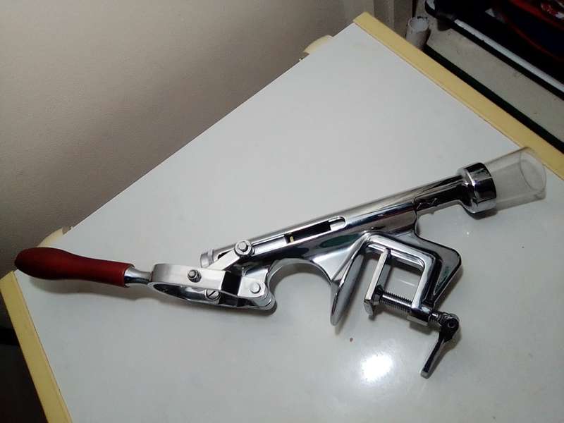 A manual working "Swing-A-Way" Ice crusher plus a table mounted Large wine bottle Cork puller.