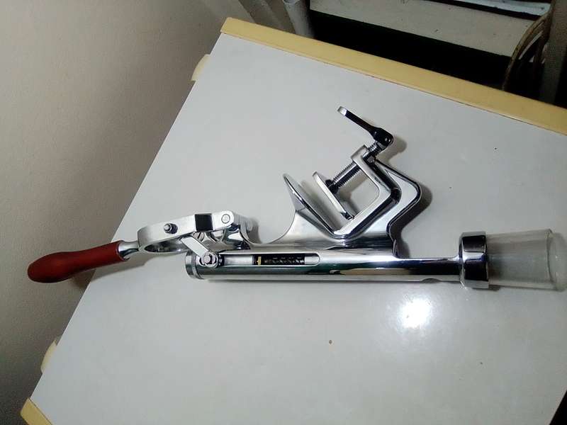 A manual working "Swing-A-Way" Ice crusher plus a table mounted Large wine bottle Cork puller.