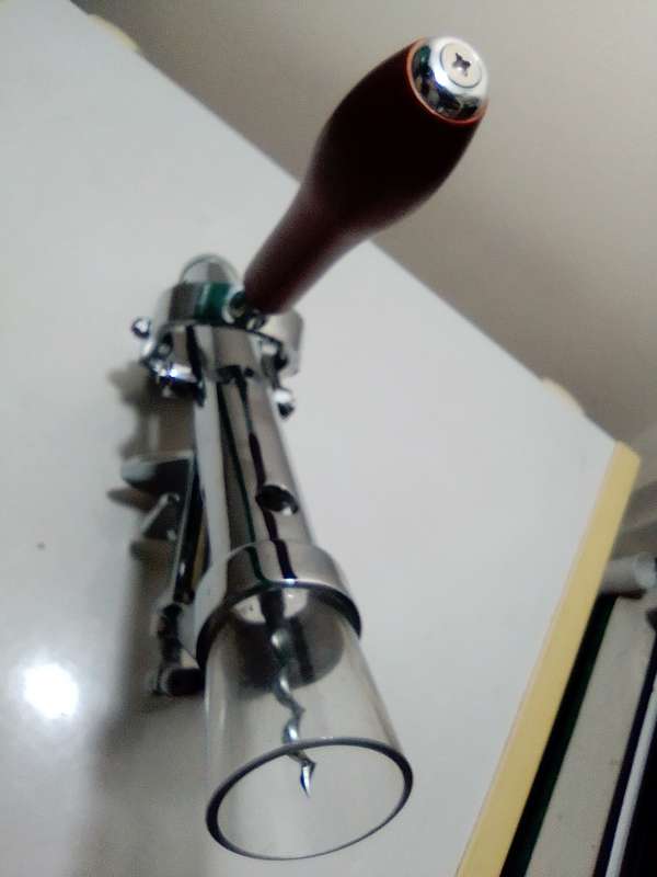A manual working "Swing-A-Way" Ice crusher plus a table mounted Large wine bottle Cork puller.