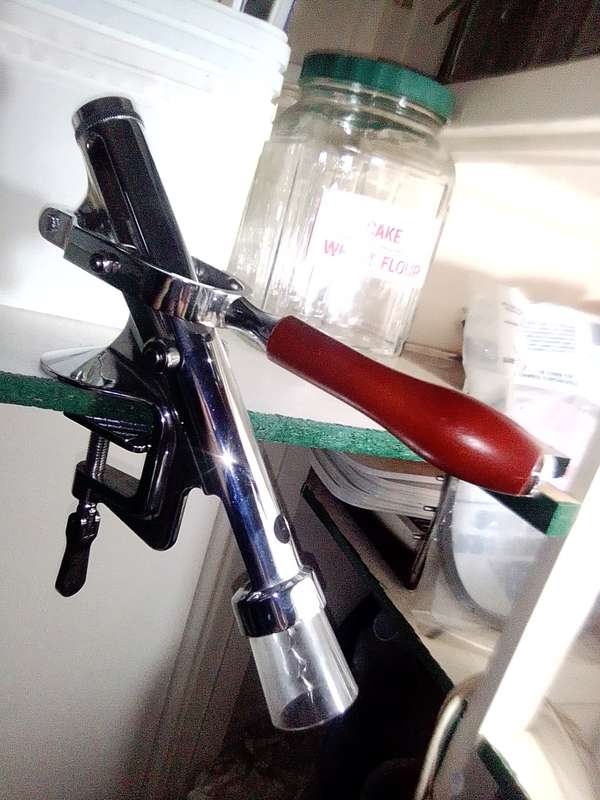 A manual working "Swing-A-Way" Ice crusher plus a table mounted Large wine bottle Cork puller.