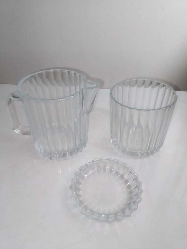 5 clean vintage glass kitchen Glass sets. 2 Water Jugs, Lidded Jar, Butter Dish. Lemon Squeeze.