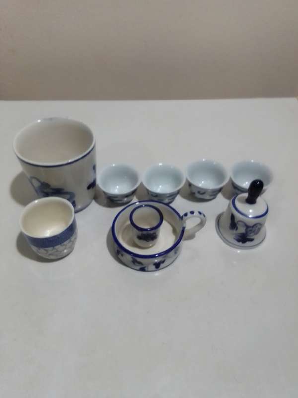 8 x Blue and White items. Delft blue Hand painted Candlestick. Bell with striker. 4 Soike cups.