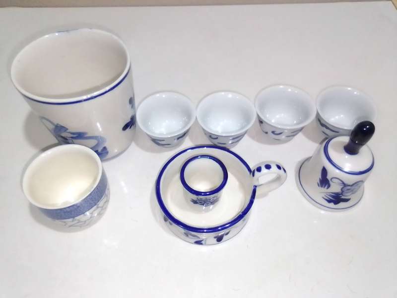 8 x Blue and White items. Delft blue Hand painted Candlestick. Bell with striker. 4 Soike cups.