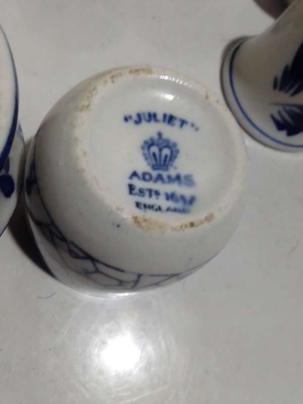 8 x Blue and White items. Delft blue Hand painted Candlestick. Bell with striker. 4 Soike cups.