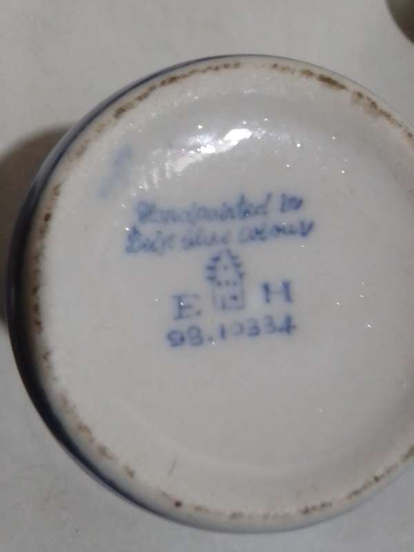 8 x Blue and White items. Delft blue Hand painted Candlestick. Bell with striker. 4 Soike cups.