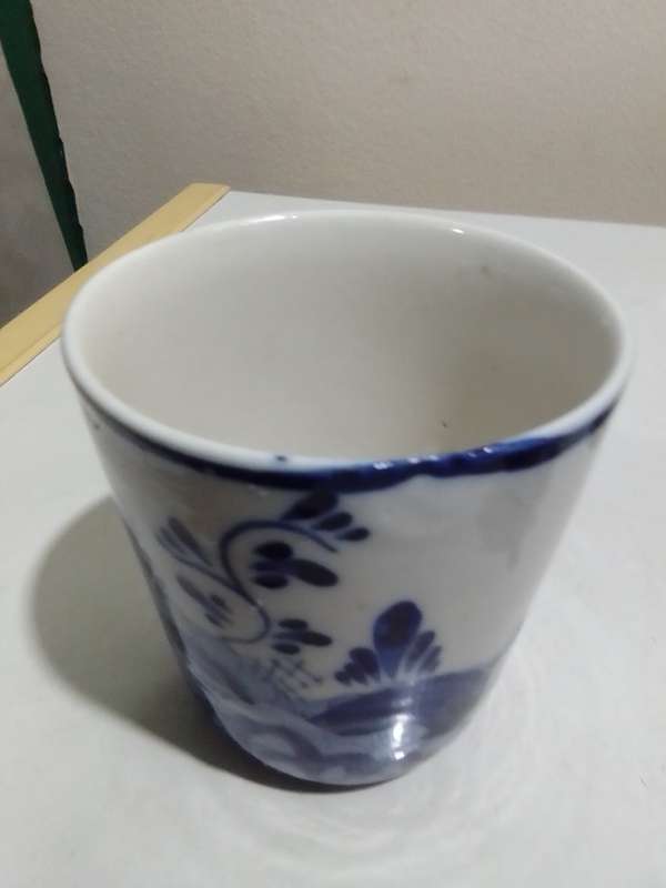 8 x Blue and White items. Delft blue Hand painted Candlestick. Bell with striker. 4 Soike cups.