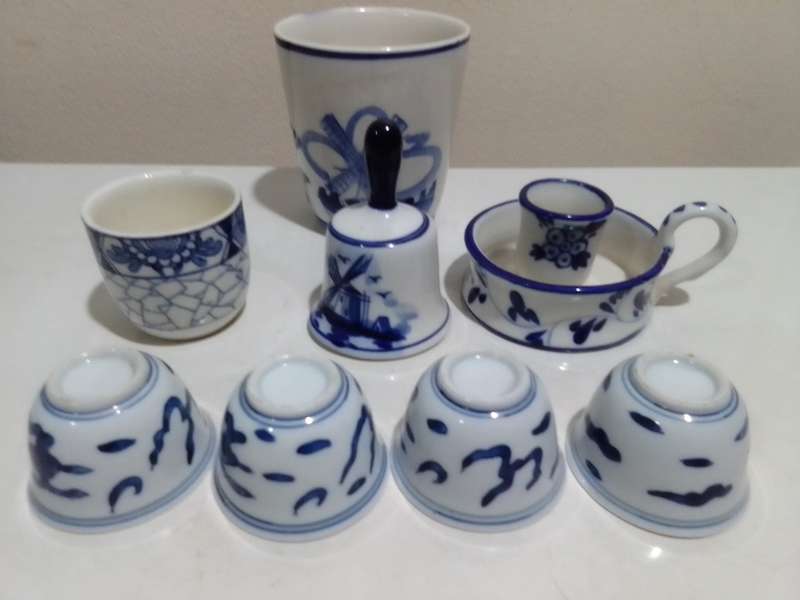 8 x Blue and White items. Delft blue Hand painted Candlestick. Bell with striker. 4 Soike cups.