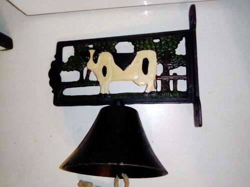An Old Vintage very heavy Cast iron kitchen Cow Bell. It has been stored a long time.