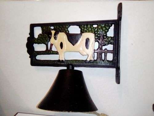 An Old Vintage very heavy Cast iron kitchen Cow Bell. It has been stored a long time.