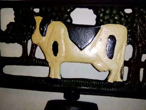 An Old Vintage very heavy Cast iron kitchen Cow Bell. It has been stored a long time.