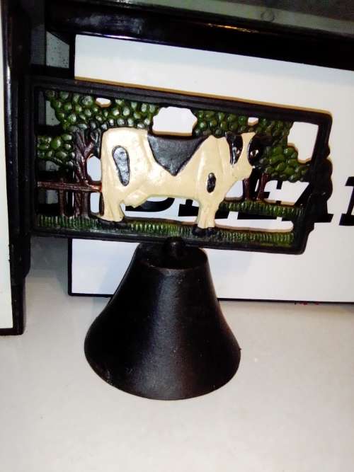 An Old Vintage very heavy Cast iron kitchen Cow Bell. It has been stored a long time.