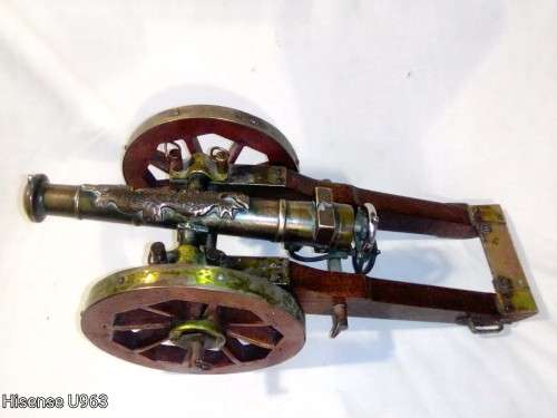 Belonged to a Sea Captain a bronze barrel Dragon motif Canon. It has a Hight adjusting wheel.