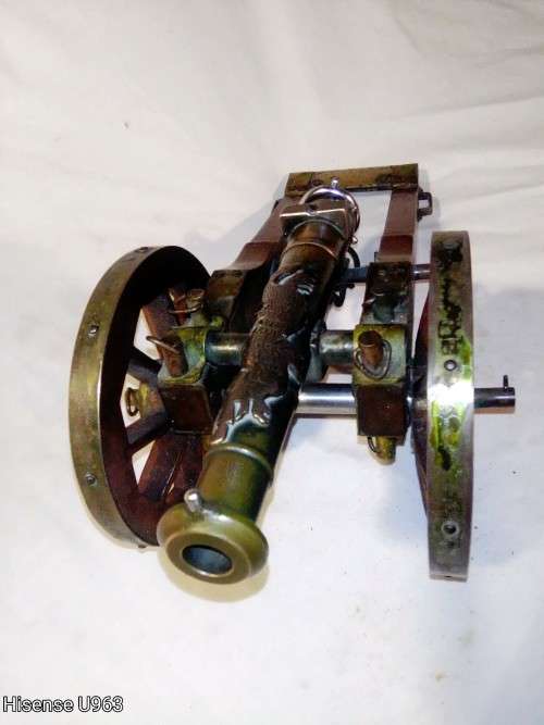 Belonged to a Sea Captain a bronze barrel Dragon motif Canon. It has a Hight adjusting wheel.
