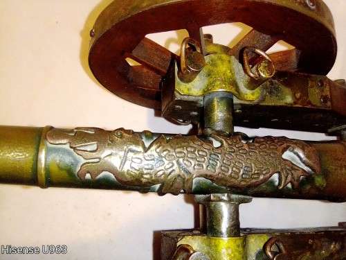 Belonged to a Sea Captain a bronze barrel Dragon motif Canon. It has a Hight adjusting wheel.