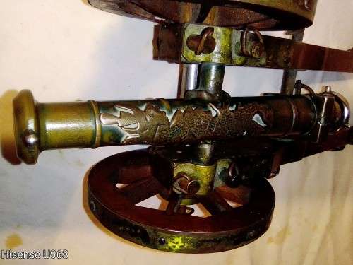 Belonged to a Sea Captain a bronze barrel Dragon motif Canon. It has a Hight adjusting wheel.