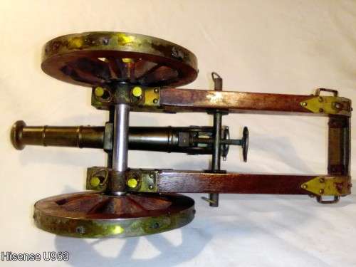 Belonged to a Sea Captain a bronze barrel Dragon motif Canon. It has a Hight adjusting wheel.