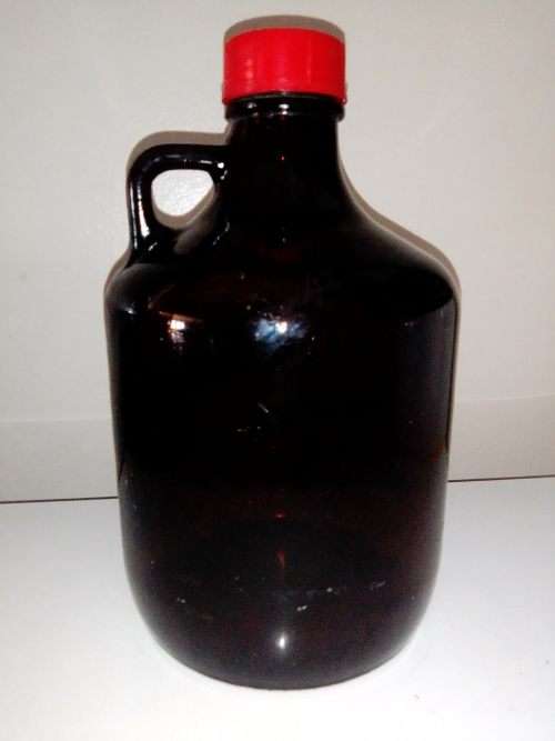 A Very Large Old vintage dark brown Medicine bottle with lid and in good second condition.