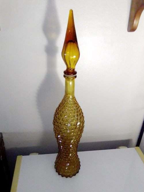 A rare old 58cm tall Amber studio glass Geni bottle in good used second hand condition.