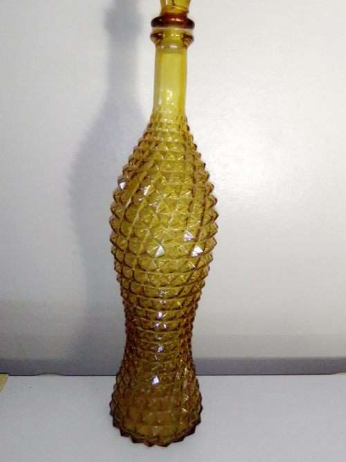 A rare old 58cm tall Amber studio glass Geni bottle in good used second hand condition.
