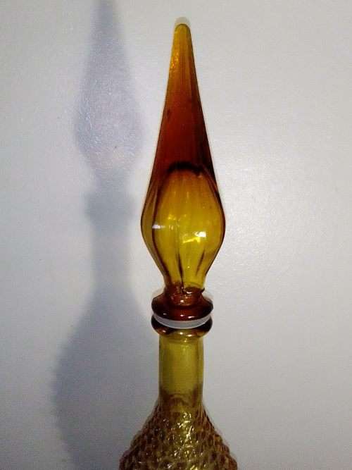 A rare old 58cm tall Amber studio glass Geni bottle in good used second hand condition.