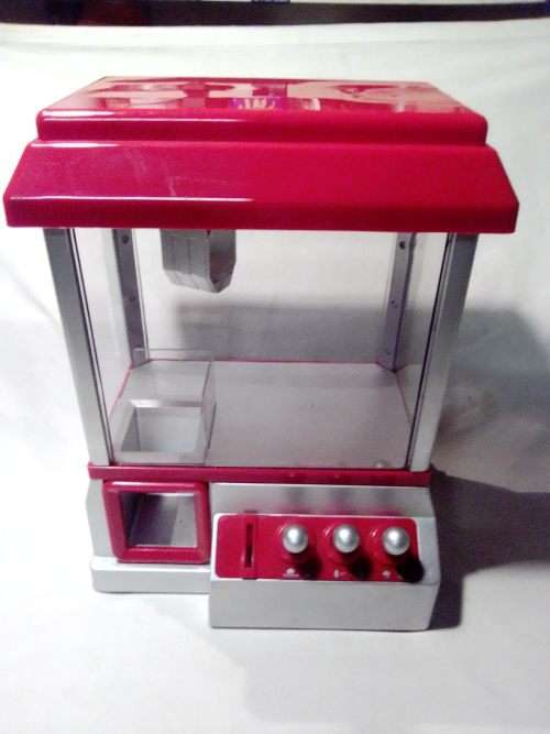A `Toy Grab Machine` been in storage a long time bu still in good condition for age.