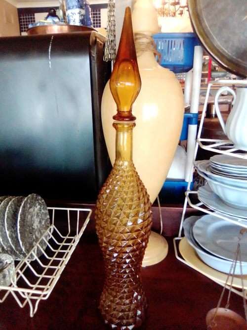 A rare old 58cm tall Amber studio glass Geni bottle in good used second hand condition.
