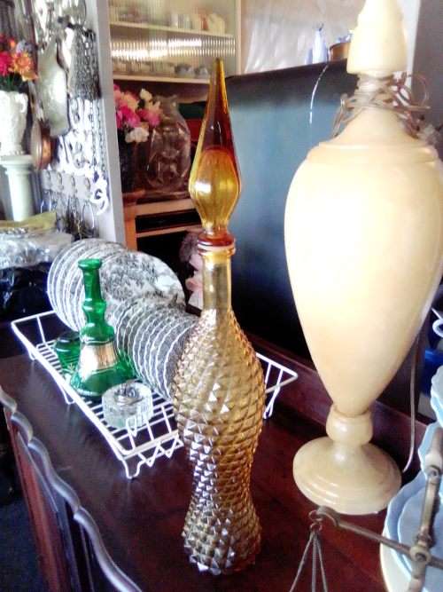 A rare old 58cm tall Amber studio glass Geni bottle in good used second hand condition.