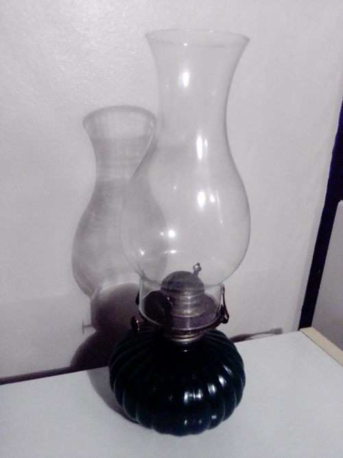 A Hunters green kerosene lamp with mantel. Made by Lamp light farms USA.