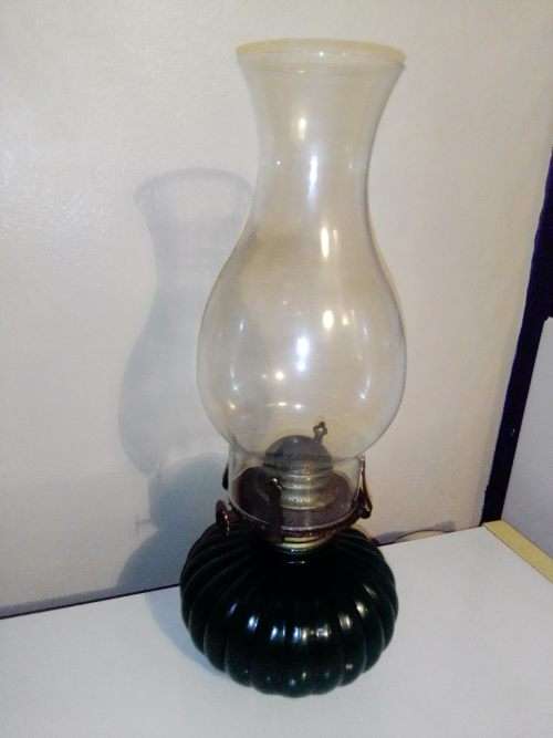 A Hunters green kerosene lamp with mantel. Made by Lamp light farms USA.
