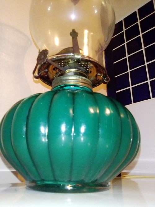 A Hunters green kerosene lamp with mantel. Made by Lamp light farms USA.