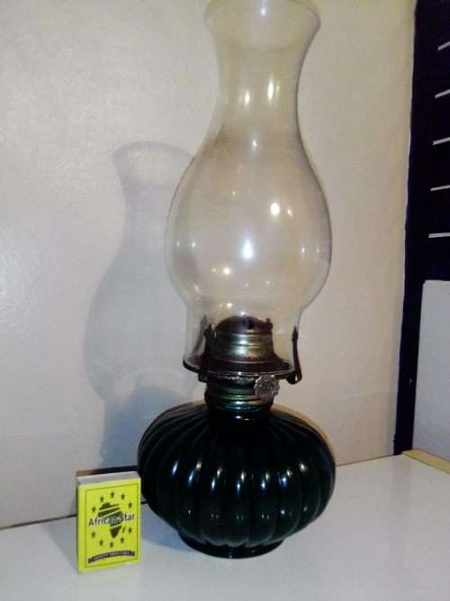 A Hunters green kerosene lamp with mantel. Made by Lamp light farms USA.