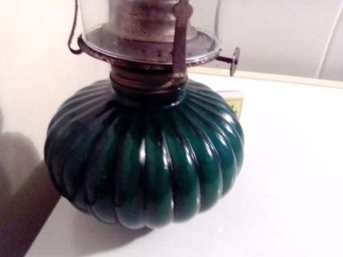 A Hunters green kerosene lamp with mantel. Made by Lamp light farms USA.