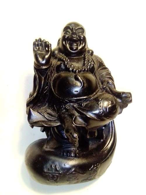 A signed black in colour ` The Laughing Buda ` very heavy and clean. Size 10cm wide x 14.5cm Tall