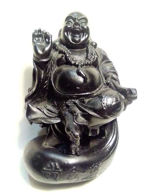 A signed black in colour ` The Laughing Buda ` very heavy and clean. Size 10cm wide x 14.5cm Tall