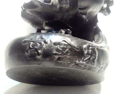 A signed black in colour ` The Laughing Buda ` very heavy and clean. Size 10cm wide x 14.5cm Tall