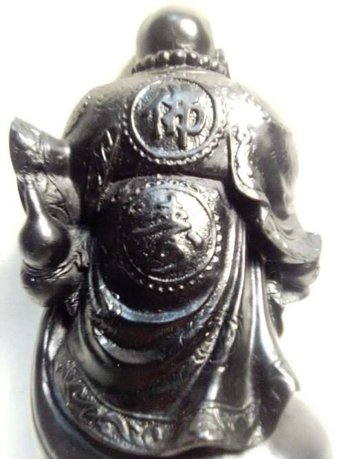 A signed black in colour ` The Laughing Buda ` very heavy and clean. Size 10cm wide x 14.5cm Tall