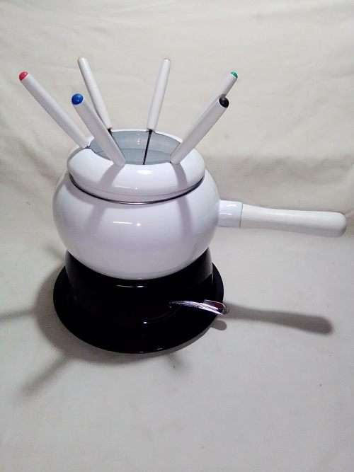 Brand New and clean. An Estate find, a German, Complete and boxed white enamel Fondue.