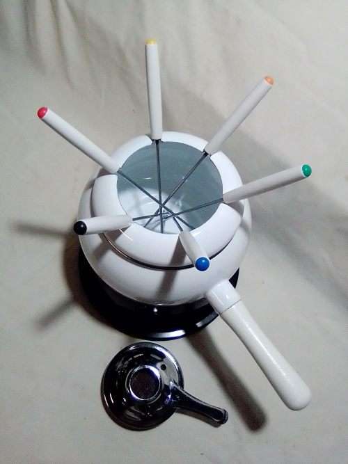 Brand New and clean. An Estate find, a German, Complete and boxed white enamel Fondue.