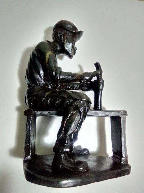 A Very heavy signed By `E. Chiwaridzo` an Ethnic worker, Cobler with hammer and all. 25cm Tall