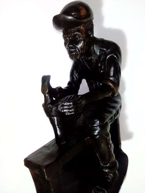 A Very heavy signed By `E. Chiwaridzo` an Ethnic worker, Cobler with hammer and all. 25cm Tall